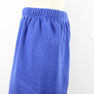 May include: A blue cotton skirt with an elastic waistband.