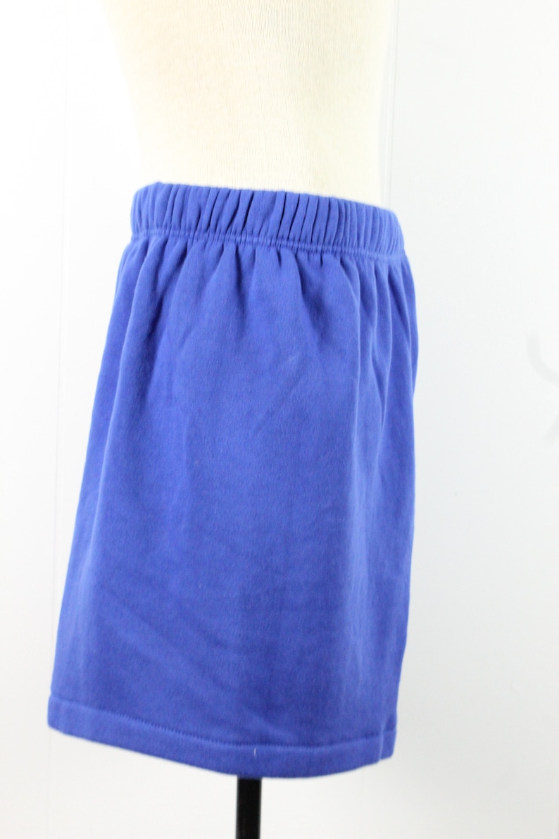 May include: A blue cotton skirt with an elastic waistband.