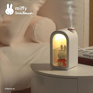 May include: A white Miffy-themed humidifier with a small Miffy figure inside. The humidifier has a rectangular design with a curved top and a small red accent. The image includes the text "miffy Dich Buuna".