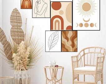 May include: A set of framed art prints featuring abstract designs in earthy tones. The artwork includes a sun and moon illustration, a line drawing of a figure, and geometric patterns. The room is styled in a bohemian aesthetic with a wicker chair and woven basket.