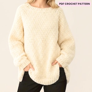 May include: Cream-colored crochet sweater with a round neckline and long sleeves. The sweater has a textured stitch pattern and a slightly curved hemline. The text "PDF CROCHET PATTERN" is in the upper right corner.