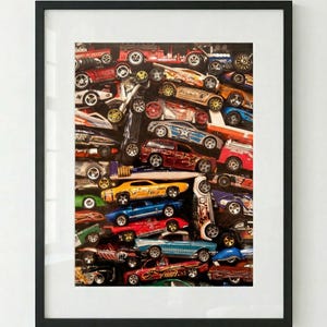 May include: A framed print featuring a collection of toy cars in various colors and designs. The cars are tightly packed together, creating a dense and colorful composition. The image includes a variety of car models, including race cars, trucks, and classic cars.
