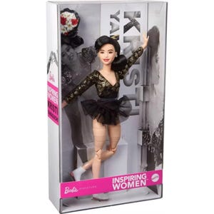 May include: A Barbie Signature Inspiring Women Kristi Yamaguchi doll in a display box. The doll has black hair, wears a black and gold long-sleeved skating outfit with a black tulle skirt, and white skates. The box features text including Kristi Yamaguchi and Inspiring Women.