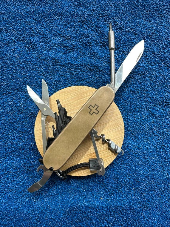 A custom-modded Victorinox CyberTool with brass scales and black G10 liners — this is genuine niche craft for Swiss Army knife nerds who want a one-of-a-kind EDC piece.