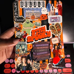 May include: A rectangular sticker sheet featuring a collage of Halloween-themed imagery, including movie titles like Beetlejuice, Hocus Pocus, and Practical Magic, alongside illustrations of Oogie Boogie, pumpkins, ghosts, and the text Stay Spooky.