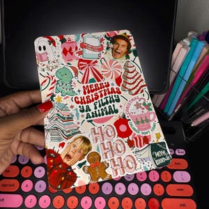May include: A decorative holiday-themed card with a collage of festive images and text. The card features images of a dinosaur in a Santa hat, a gingerbread man, and a character from the movie "Elf." The text includes "Merry Christmas Ya Filthy Animal" and "Ho Ho Ho."