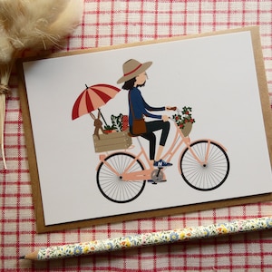 Carte postale "A vélo avec mon lapin", série "Un lapin à la maison"