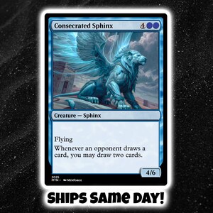 May include: A blue trading card featuring a winged sphinx illustration. The card is labeled "Consecrated Sphinx" and includes the text "Creature - Sphinx" and "Flying." The card also has the text "Whenever an opponent draws a card, you may draw two cards." The card is set against a black background.