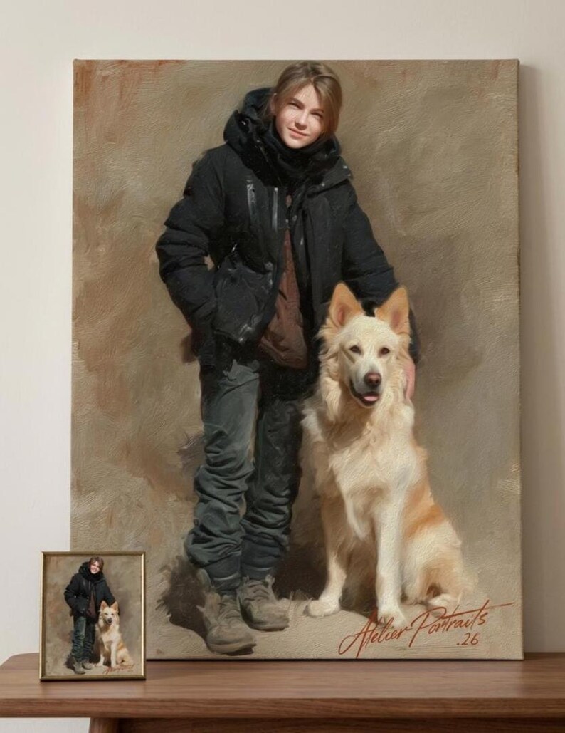 May include: An oil painting portrait of a person and a dog. The person is wearing a black jacket and dark pants, standing next to a cream-colored dog. A smaller framed version of the painting is in the foreground. The painting is signed "Atelier Portraits .26".