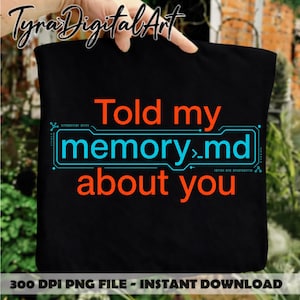 May include: A black tote bag featuring the orange text "Told my" and "about you" with the blue text "memory.md" enclosed in a digital-style frame. The design includes small binary code sequences in blue, creating a tech-inspired graphic print.