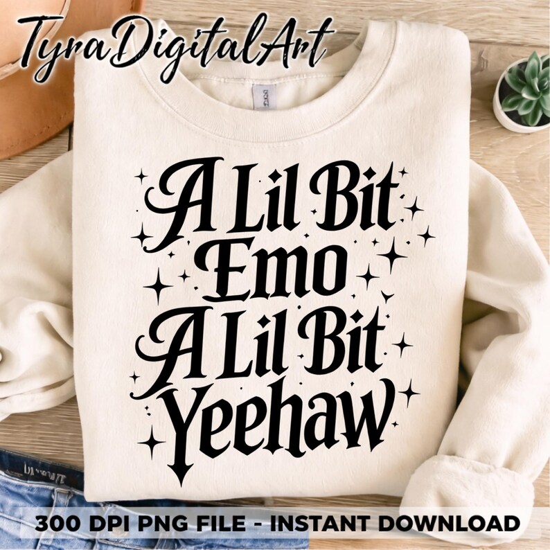 May include: A cream-coloured sweatshirt featuring the text "A Lil Bit Emo A Lil Bit Yeehaw" in black script, with star accents. The casual sweatshirt is suitable for everyday wear.