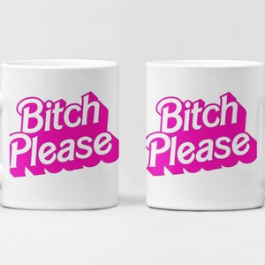 May include: Two white ceramic mugs, each bearing the pink phrase "Bitch Please". The mugs have a classic handle design and a clean, minimalist aesthetic, perfect for hot beverages.