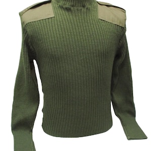 May include: An olive green ribbed knit sweater featuring a mock neck collar and solid fabric shoulder epaulets. The long-sleeved garment has a textured vertical knit pattern throughout the torso and sleeves, with matching ribbed cuffs at the wrists.