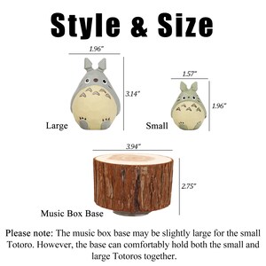 May include: The image displays a music box base and two Totoro figurines, labeled "Large" and "Small." The large Totoro is 3.14 inches tall, and the small one is 1.96 inches tall. The music box base is 2.75 inches tall and 3.94 inches wide. The text "Style & Size" is at the top.