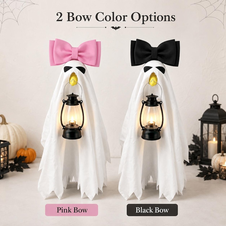May include: Two ghost-shaped decorations featuring white fabric drapes, black eye patches, and yellow beaks. Each ghost holds a black lantern and wears a large bow on top, one in pink and one in black. The text 2 Bow Color Options is displayed above.