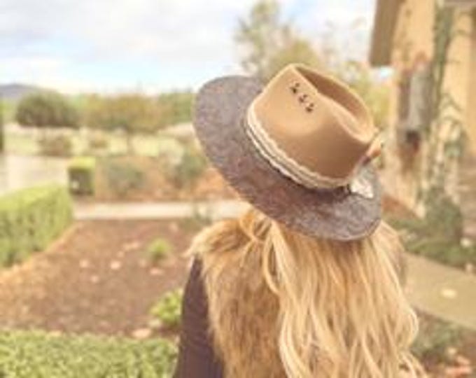 100% wool Tan Rancher Hat with tooled leather handstitched to the brim with gold accents.
