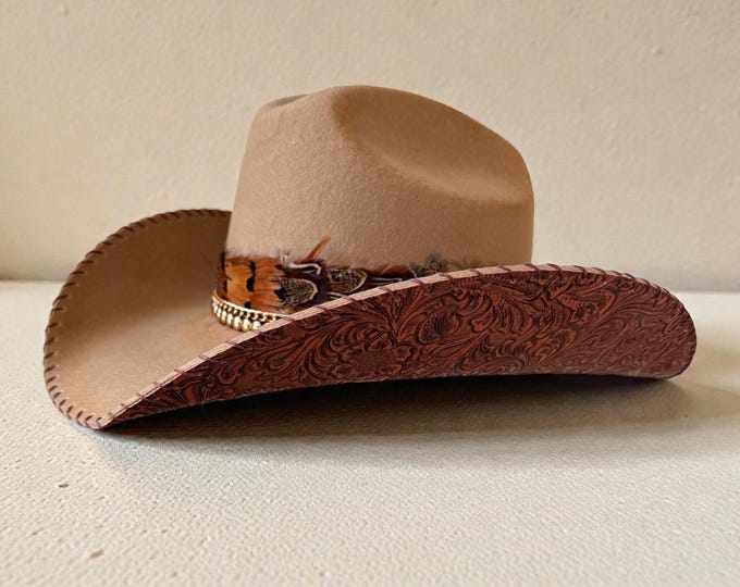 100% wool tan cowboy hat with brown tooled leather handstitched to brim