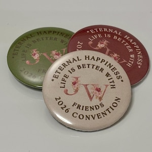 Puede incluir: Tres botones redondos con el texto "Eternal Happiness, Life is Better With" y "Friends Convention". Los botones son en tonos verdes, burdeos y rosa claro, con detalles florales y las letras "JW".