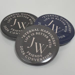 May include: Three round buttons with the text "Eternal Happiness, Life is Better With" and "JW" in a stylized font. The buttons are in shades of gray and navy blue, with the text "2026 Friends Convention".
