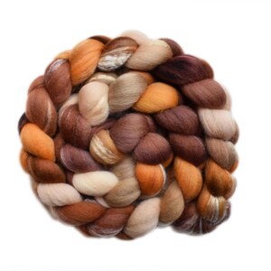 May include: A thick, braided bundle of unspun wool roving featuring a warm color palette of cream, beige, tan, golden orange, and deep chocolate brown. The fibers are soft and textured, arranged in a circular, intertwined pattern of yarn.
