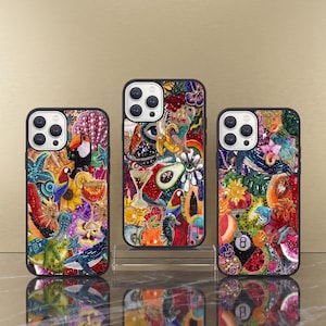 May include: Three phone cases with bright, colourful designs. The cases feature images of toucans, cocktails, and floral patterns. Each case has a black border and a camera cutout. The designs are intricate and eye-catching, with a variety of colours.