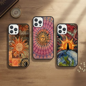 May include: Three phone cases with vibrant sun designs. One case features a collage of sun imagery, another a mandala-style sun, and the third a sunset with a black cat silhouette. The cases are on a wooden surface.