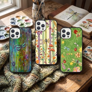 May include: Three smartphone cases featuring distinct designs: one with a teal dragonfly on a multicoloured drip background, one with a dragonfly and mushrooms on vertical stripes, and one with a green background featuring dragonflies and ladybugs.