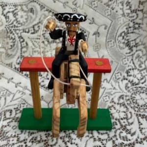 Vintage Don Shinda charro on horseback mobile wooden toy with clay pendulum