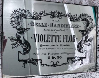 Vintage French decorative mirror with Art Nouveau-inspired perfume ad from La Belle Jardiniere