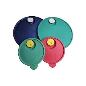 May include: A collection of four colorful, round plastic lids in varying sizes. The lids are in shades of blue, teal, green, and red. Each lid has a white or yellow circular handle. The lids are designed to fit on containers.