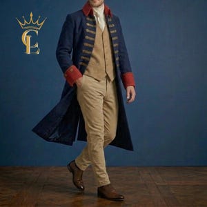 May include: A long navy blue coat with red cuffs and gold buttons, worn over a tan waistcoat, a white collared shirt, and tan trousers. The ensemble is completed with brown leather shoes. A gold logo featuring the letters CL is visible in the corner.