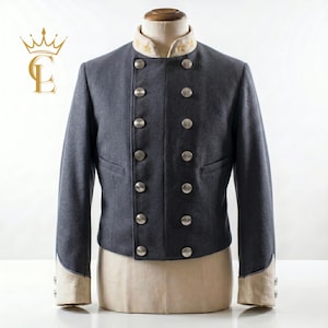 May include: A gray jacket with silver buttons and a cream-colored collar. The jacket has a double-breasted design with eight buttons and a tailored fit. The collar is adorned with gold star embroidery. The jacket is displayed on a mannequin.