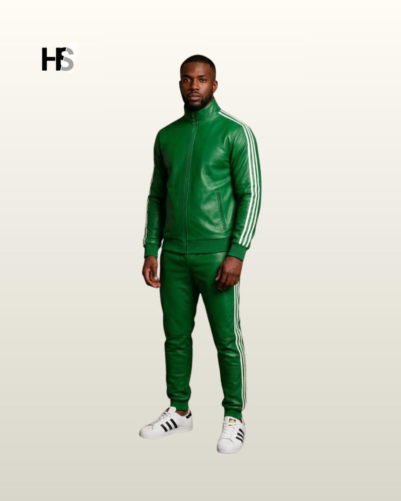 May include: A green leather tracksuit featuring a full-zip jacket with a high collar and matching slim-fit trousers. Both pieces are accented with three white stripes running down the sleeves and legs. The outfit is paired with white sneakers.