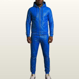May include: A bright blue leather tracksuit featuring a zip-up hooded jacket with long sleeves and matching slim-fit trousers. Both pieces are accented with white side stripes. The jacket includes a front zipper closure and a drawstring hood.
