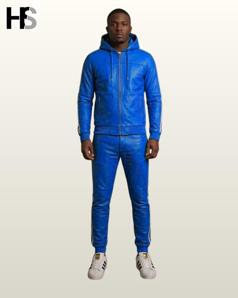 May include: A bright blue leather tracksuit featuring a zip-up hooded jacket with long sleeves and matching slim-fit trousers. Both pieces are accented with white side stripes. The jacket includes a front zipper closure and a drawstring hood.