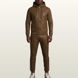 May include: A brown leather tracksuit consisting of a hooded zip-up jacket with long sleeves and matching trousers. The jacket features a front zipper, a hood with drawstrings, and side pockets. Both pieces have white side stripes and ribbed cuffs.