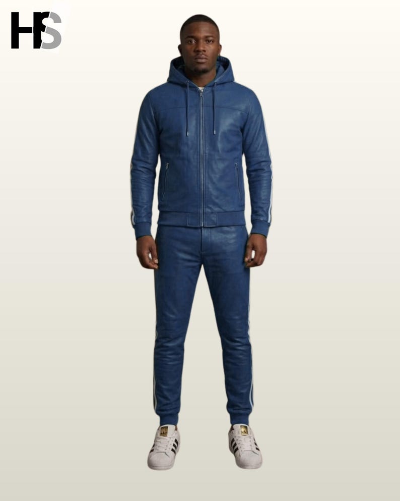 May include: A blue leather hooded jacket with a front zipper and matching blue leather joggers. Both pieces feature white side stripes. The jacket has a drawstring hood and ribbed cuffs, while the pants have a fitted waistband and ribbed ankles.