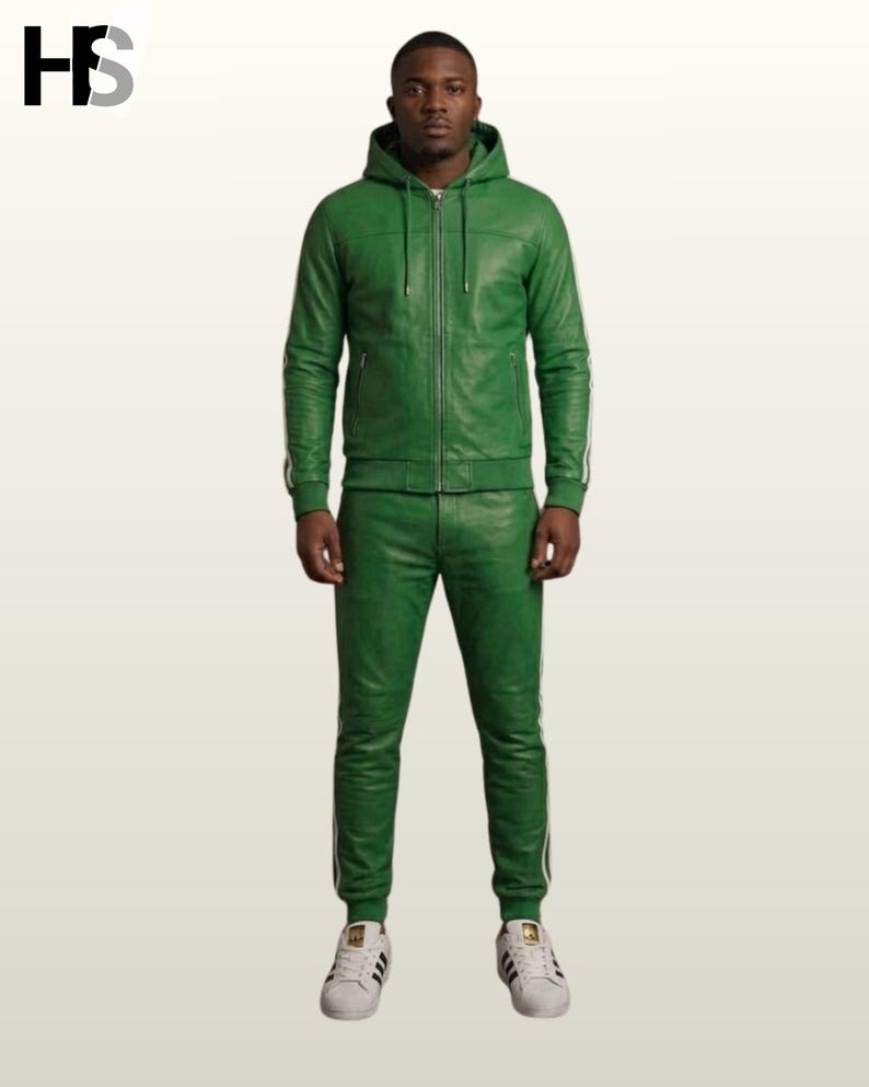 May include: A green leather tracksuit consisting of a hooded jacket with a full-length front zipper and matching slim-fit trousers. Both pieces feature white side stripes along the sleeves and legs. The outfit is paired with white sneakers.