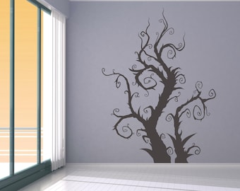 May include: A wall decal featuring a silhouette of a dark, twisted tree with intricate branches and swirling vines. The tree is set against a light gray wall.