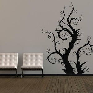 Artistic tree decal placed near a window where shifting light traces the branches, giving the design a changing presence throughout the day.