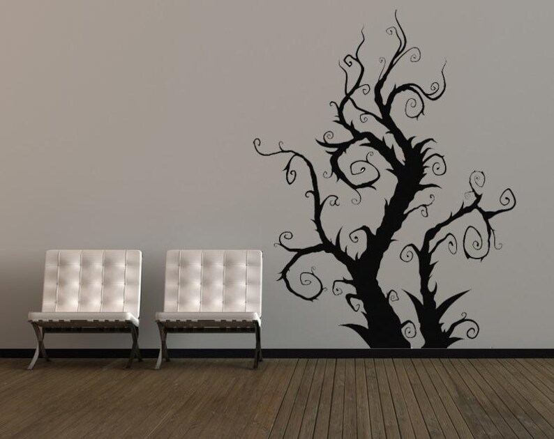 Artistic tree decal placed near a window where shifting light traces the branches, giving the design a changing presence throughout the day.