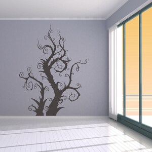 Whimsical tree decal showing dramatic curling limbs and flowing movement that feels magical, artistic, and slightly mysterious without heavy detail.