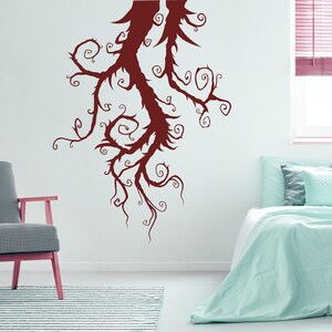 Artistic tree silhouette featuring flowing lines and curling branches that give a sense of movement and personality rather than symmetry or realism.