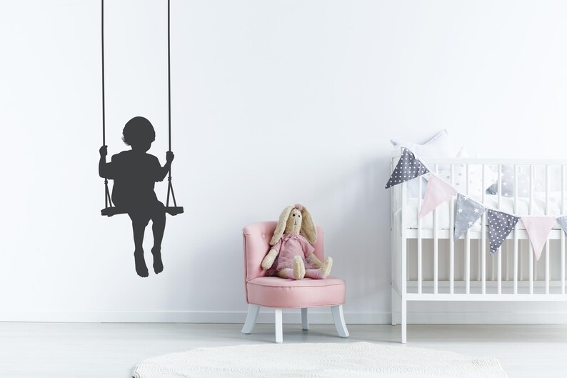 Swing wall decal showing a child silhouette on a rope swing, created to add a soft nostalgic moment that feels like quiet joy suspended in time.