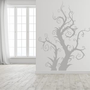 Spooky tree wall decal with twisting branches that stretch upward in an unusual organic form, blending gothic, fantasy, and artistic decor styles.