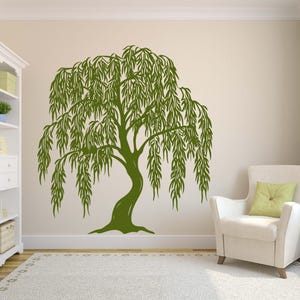 May include: A green silhouette of a weeping willow tree with long, flowing branches. The tree is on a white wall in a room with a white armchair.