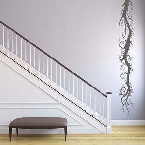 Swirling vine wall art presents a fantasy inspired tree shape, with flowing lines that move upward like a story unfolding.