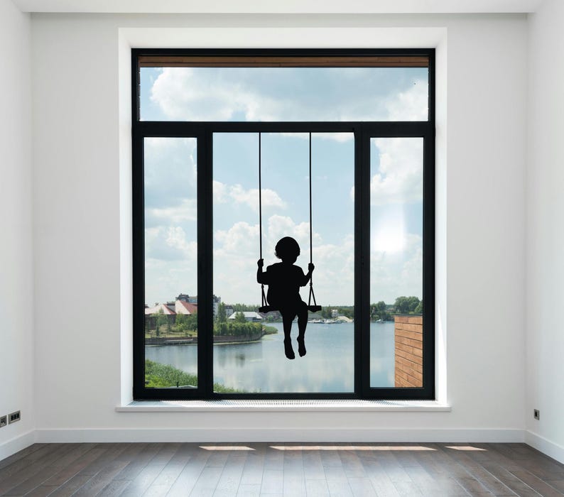 Silhouette swing wall artwork featuring a child sitting quietly in motion, made to create a comforting little moment of imagination and calm.