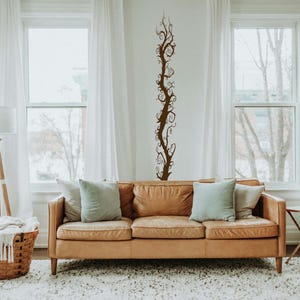 Vine wall decal works well for a renter who wants a tall statement piece that feels artistic and expressive without permanent changes.