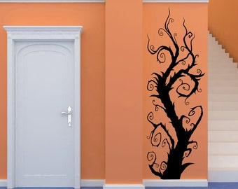 May include: A black silhouette of a tree with twisting branches and swirling vines on an orange wall. The tree is a wall decal.